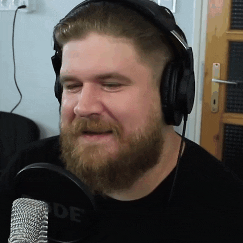 a man with a beard wearing headphones and a shirt that says rode on it