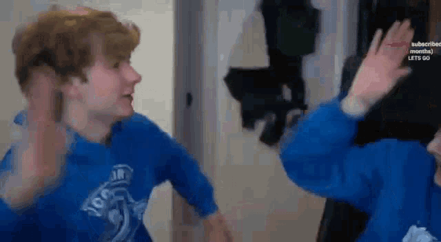 a couple of people are standing next to each other in a room .