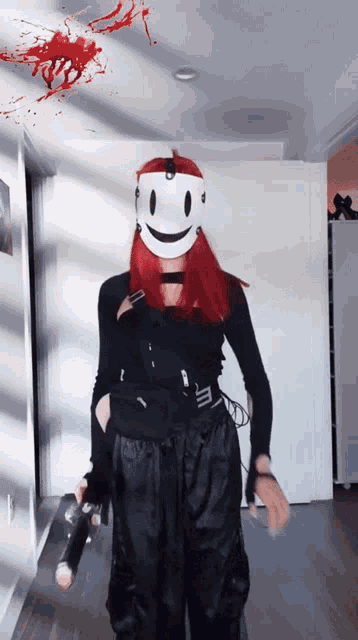 a woman wearing a white mask with a smiling face on it
