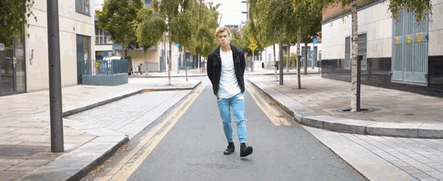 a man is walking down a street with a yellow sign that says ' no parking ' on it