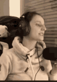 a woman wearing headphones and a microphone is singing