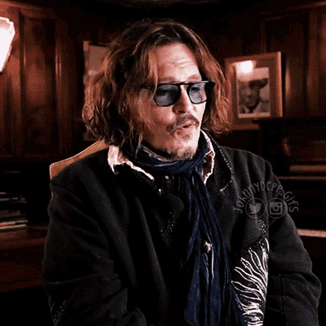 a man wearing sunglasses and a scarf with the words johnny depp gifs on the bottom right