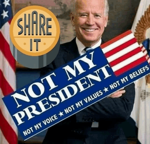 joe biden holds a sign that says not my president