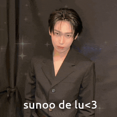 a young man in a suit with the words sunoo de lu < 3 on the bottom