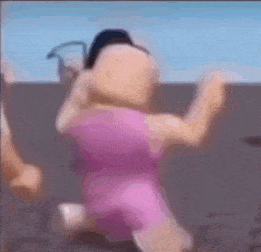 a blurry picture of a person in a pink dress dancing on a beach .
