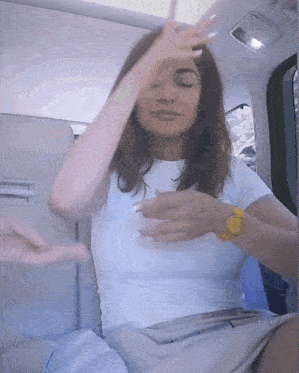 a woman in a white shirt with a yellow watch on her wrist