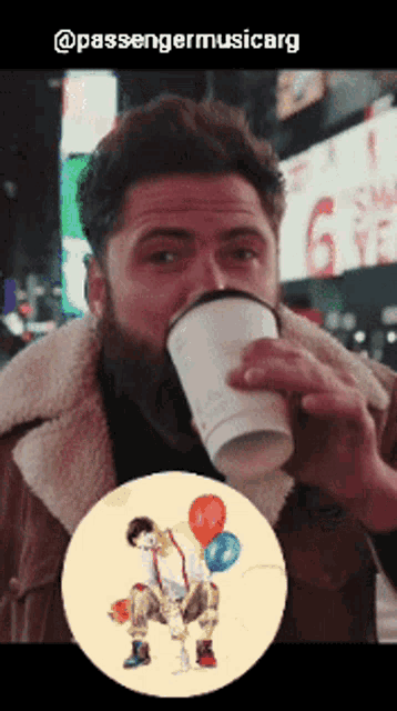 a man drinking from a coffee cup with a picture of a clown behind him