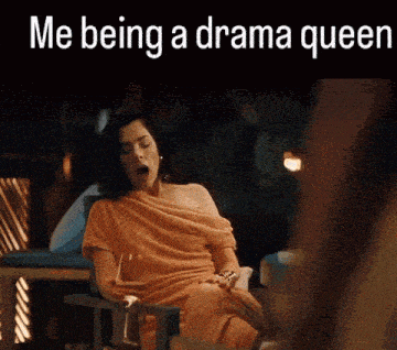 a woman is sitting in a chair with a glass of wine and the words me being a drama queen