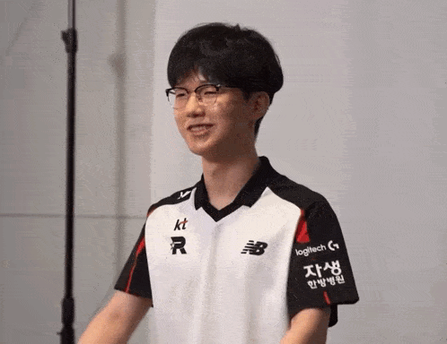 a man wearing glasses and a black and white shirt that says logitech on the sleeves