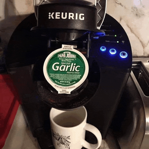 a keurig coffee maker with a k cup of papa johns special garlic dipping sauce