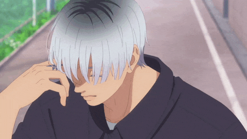 a man with gray hair has his hand on his face
