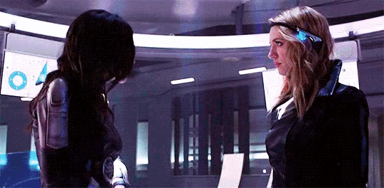 a couple of women are standing next to each other in a room .
