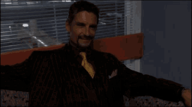 a man with a beard wearing a suit and tie