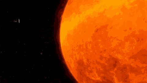 a space ship is flying in front of a bright orange sun in space .