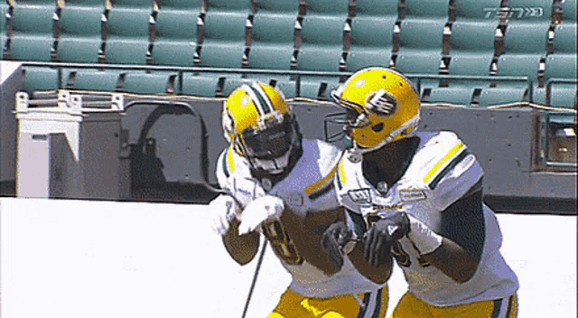 two green bay packers football players are running towards each other