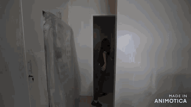 a person standing in a room with the words made in animatica on the bottom right