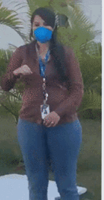 a woman wearing a mask and a lanyard with a skull logo