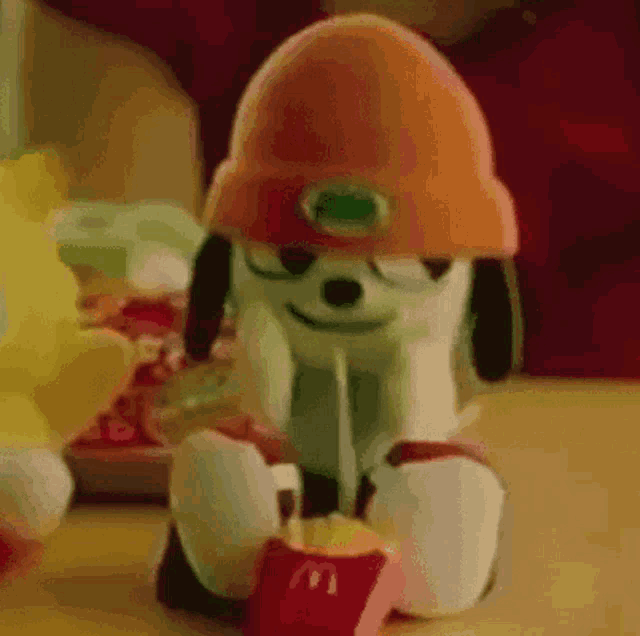 a stuffed animal is eating french fries from a mcdonalds box