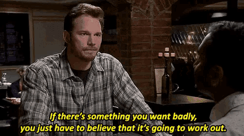 a man in a plaid shirt is talking to another man in a restaurant and says if there 's something you want badly