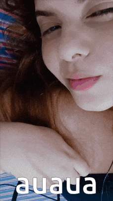 a close up of a woman 's face with the word auaua written below it