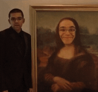 a man in a suit stands next to a framed portrait of a smiling woman