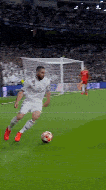a soccer player in a white jersey with fly emirates on it