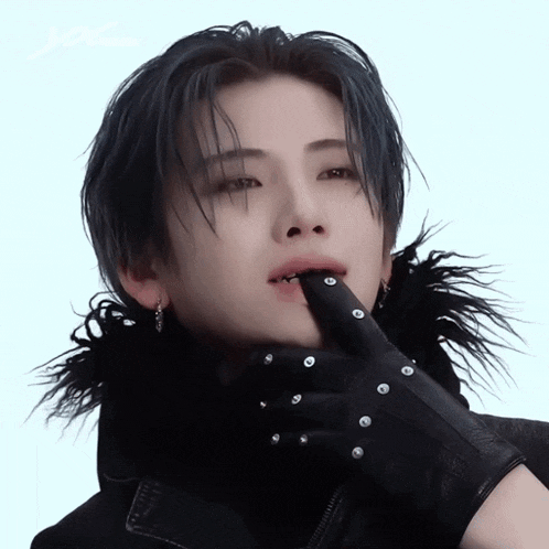 a close up of a person wearing a black glove with studs