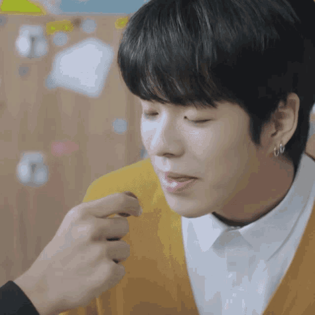 a close up of a person feeding another person a chocolate