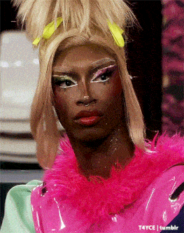 a close up of a drag queen 's face with a pink feathered collar