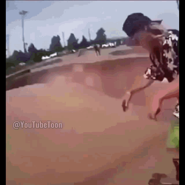 a person is riding a skateboard on a dirt road with a youtube toon logo on the bottom