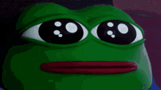 a close up of a green frog with big eyes and a red mouth .
