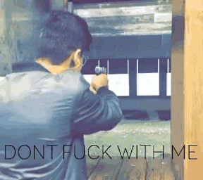a man is aiming a gun at a target with the words dont fuck with me below him