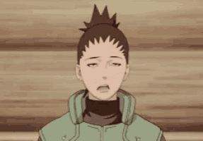 a close up of a cartoon character with his eyes closed and his hair in a ponytail .