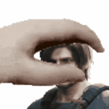 a pixelated image of a hand holding a man 's eye