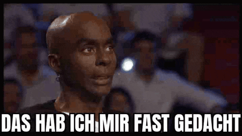 a bald man says das hab ich mir fast gedacht in front of a crowd of people