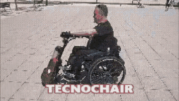a man in a wheelchair is riding a red scooter with the word tecnochair on it
