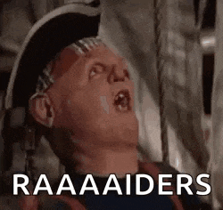 a man in a pirate hat is laying down with his mouth open and the words `` raaaaaiders '' written above him .