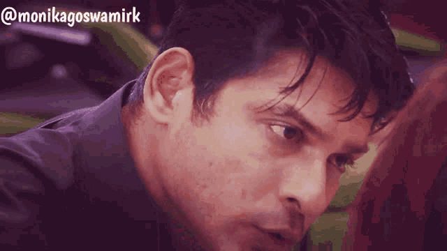 a close up of a man 's face with the words @monikagoswamirk on the bottom