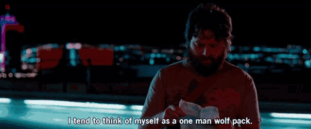 a man with a beard says i tend to think of myself as a one man wolf pack while holding a piece of paper