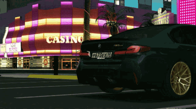 a car is parked in front of a casino with neon lights