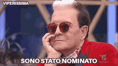 a man wearing sunglasses and a red jacket says sono stato nominato