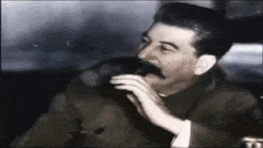 a black and white photo of a man with a mustache and the letters ts on his shirt