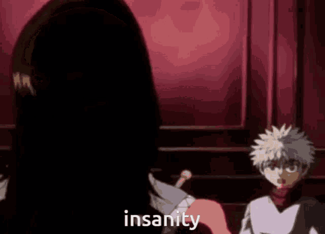 a man and a woman are standing next to each other in a dark room and the man is saying insanity .