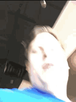 a man in a blue shirt making a funny face