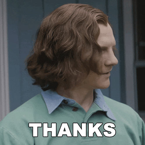 a man in a green shirt has the word thanks written on his face