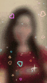 a blurry picture of a woman with hearts floating around her face
