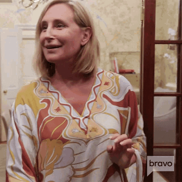 a woman stands in front of a door with a bravo logo on it