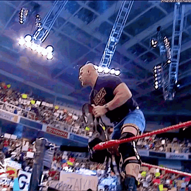 a man in a wrestling ring wearing a shirt that says ' u.s.a. ' on it