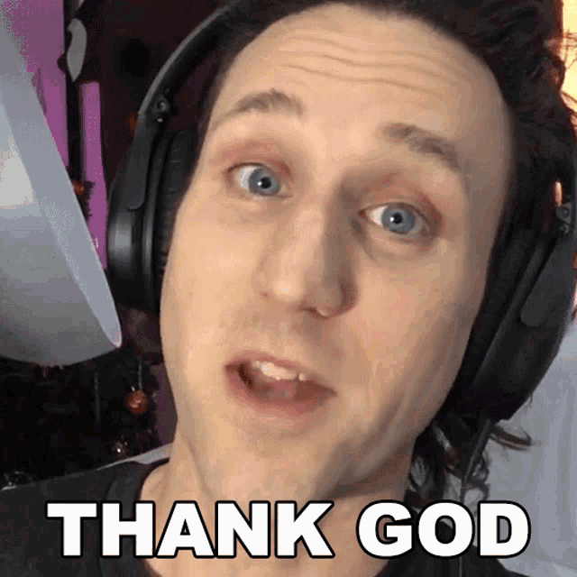 a man wearing headphones is making a thank god gesture