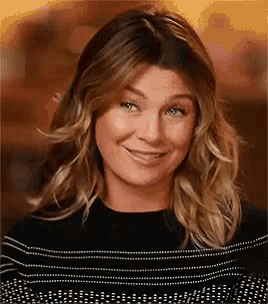 a close up of a woman 's face with a smile on her face .